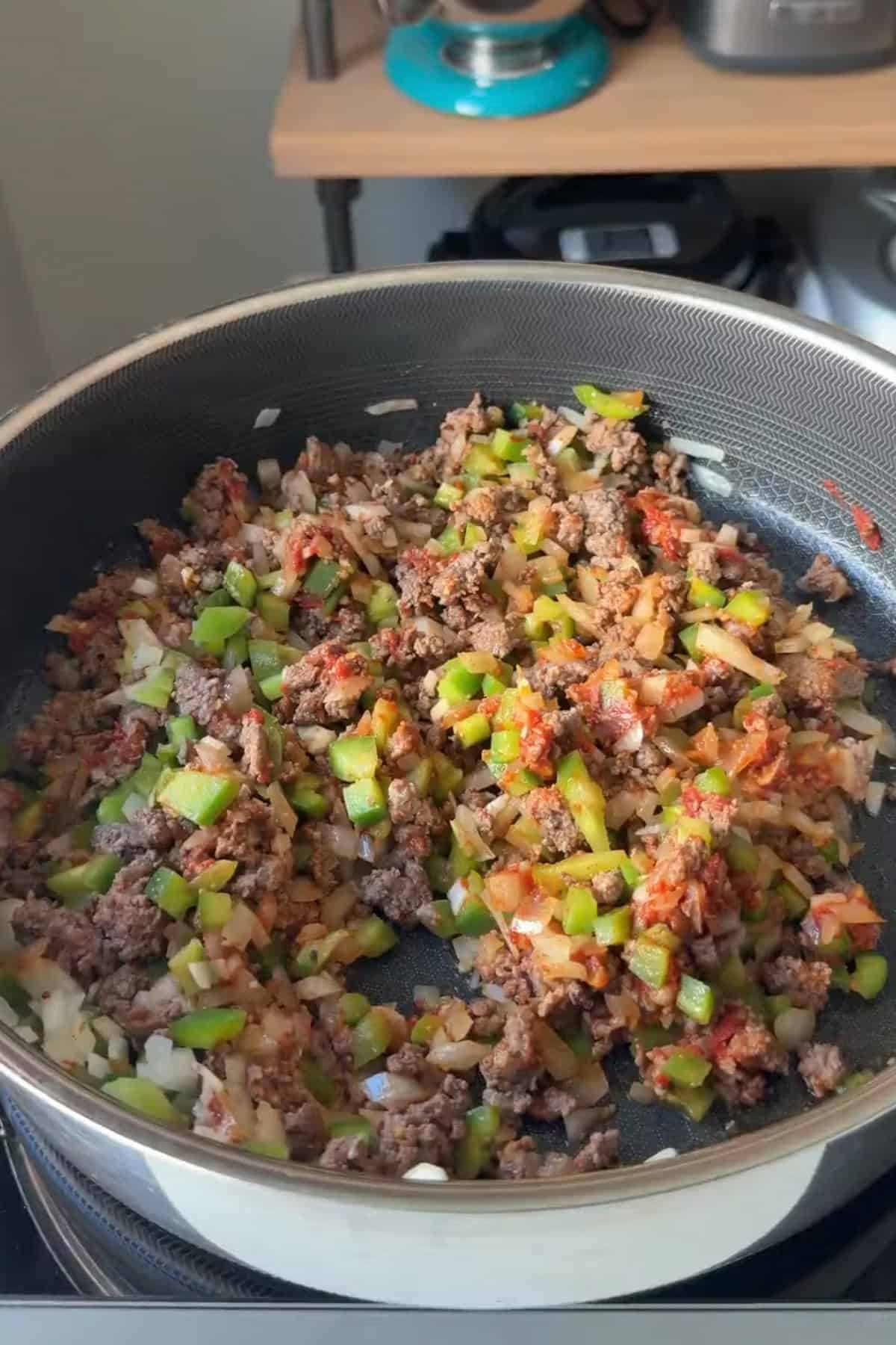 Vegetables added to the beef mixture.