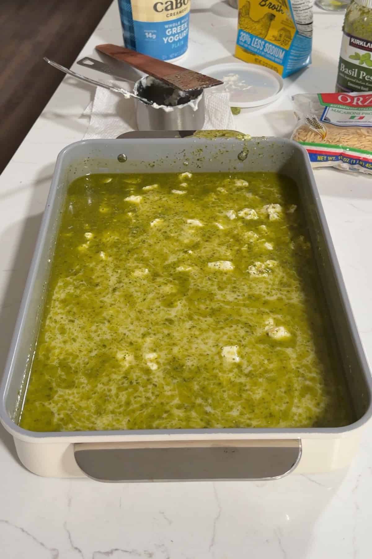 Orzo soaked in pesto and cheese and broth.