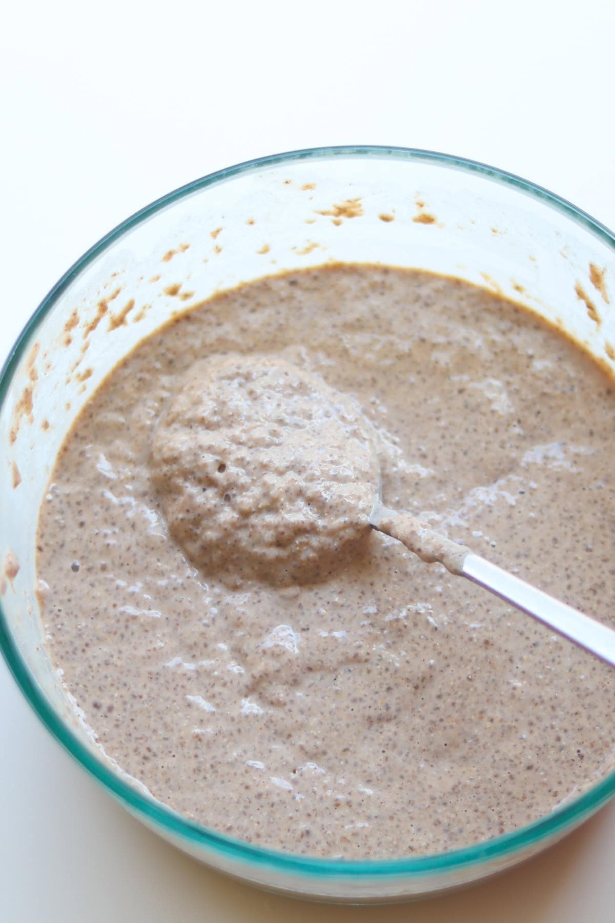 Thickened protein chia pudding in a glass bowl.