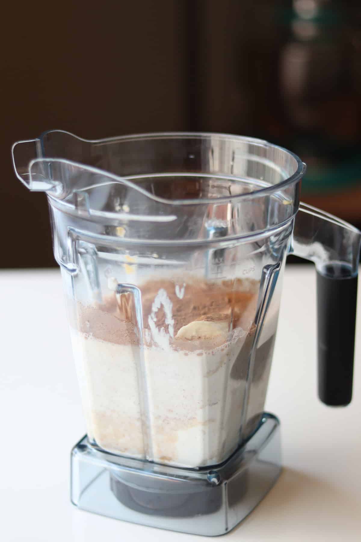 Lentils and milk added to a blender.