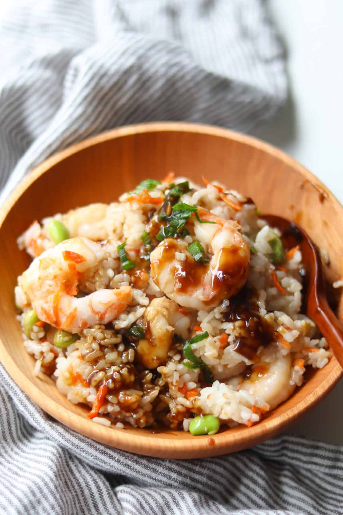 Cooked rice cooker shrimp with vegetables served in a wooden bowl.